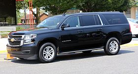 2015 Chevrolet Suburban LT in black, front left side view.jpg